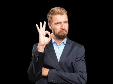 Business professional in a suit making an okay hand gesture, representing satisfaction and confidence