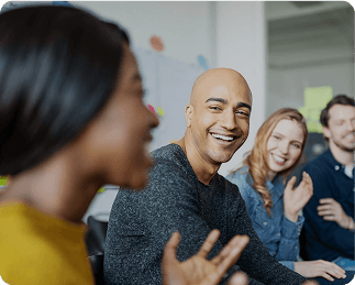 Group of business professionals discussing compliance strategy around a desk – stay legally compliant with expert business support