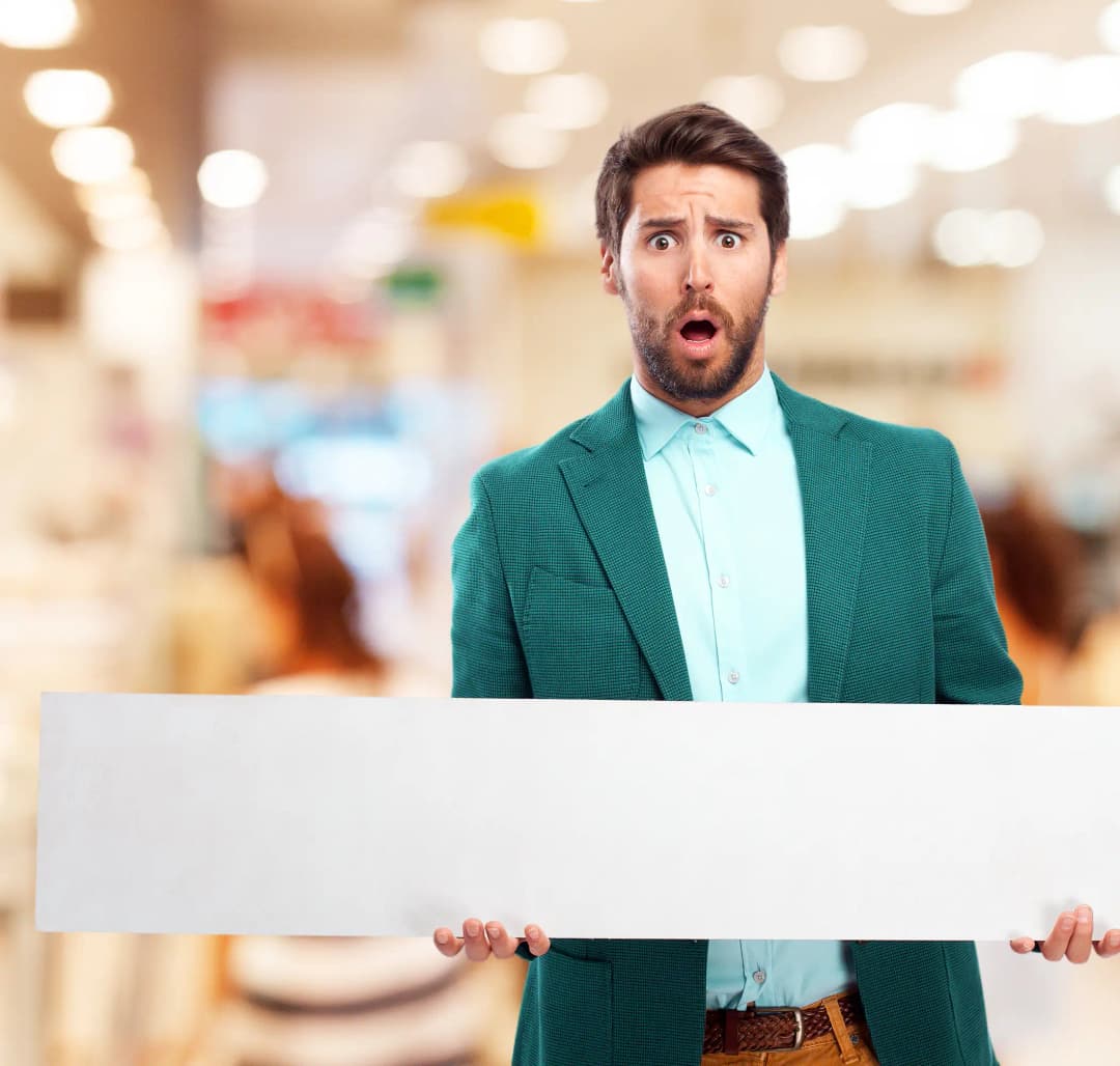 Business professional in formal attire holding a signboard with a surprised expression, illustrating discovering and securing your unique business name for brand identity and business formation.